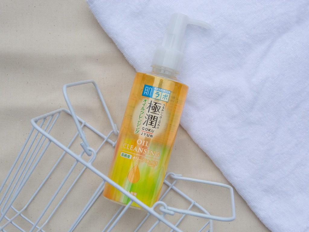 Hada Labo Gokujyun Cleansing Oil  japanese cleanser cleansing oil product lying on the ground with white cloth stylish lifestyle photo high quality product review 肌ラボオイルクレンジング