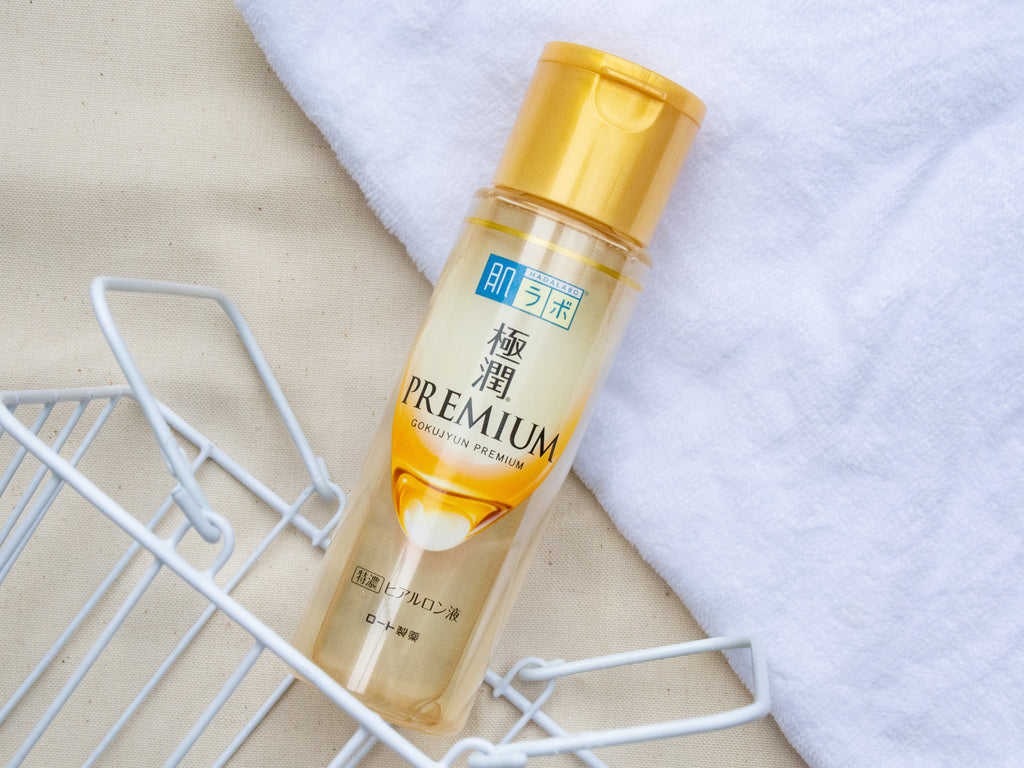 Hada Labo Gokujyun Premium Lotion bottle with golden cap on a light background, showcasing its moisturizing properties.